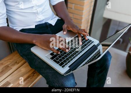 Businessman typing on laptop while working from home Stock Photo