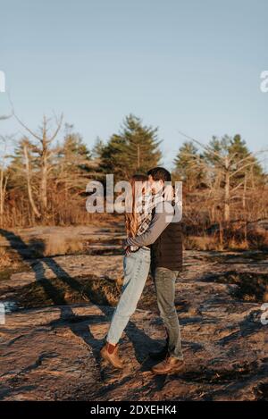 Young couple embracing during autumn hike Stock Photo