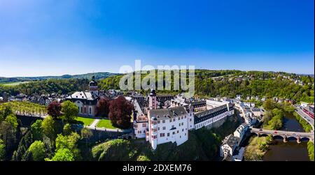 Germany, Weilburg, Weilburg Castle with baroque palace complex, old town hall and castle church with tower, aerial view Stock Photo