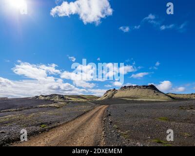 Dirt road leading towards mountain against blue sky, Lakagigar, Iceland Stock Photo