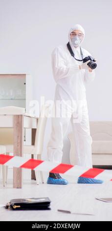 The forensic expert at crime scene doing investigation Stock Photo