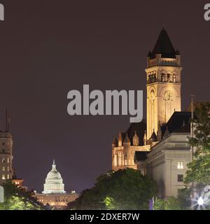 USA, Washington DC, Tower of Old Post Office at night with United States Capitol in background Stock Photo