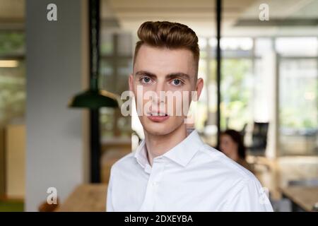 Young businessman standing at office Stock Photo