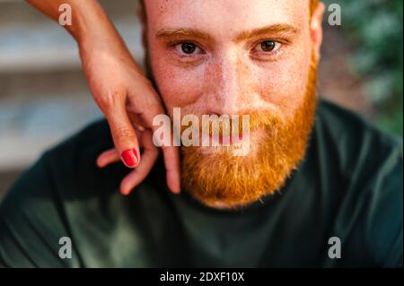 Girlfriend's hand touching boyfriend's face Stock Photo