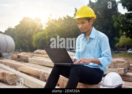 Engineering use computer notebook presentation at work place building estate construction background Stock Photo