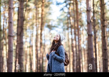 Smiling female hiker exploring in Cannock Chase woodland Stock Photo