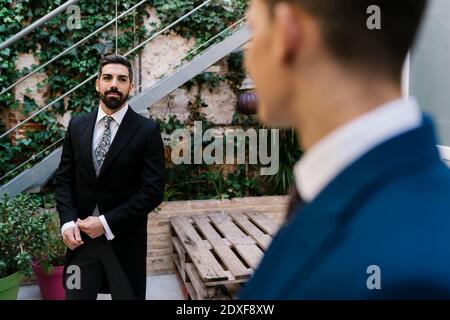 Young grooms well dressed in garden on wedding day Stock Photo