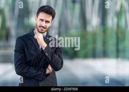 Businessman staring while standing outdoors Stock Photo