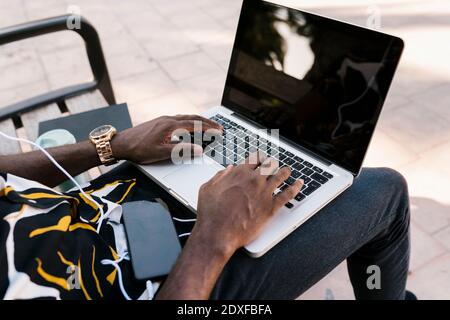 Hands of male entrepreneur typing on laptop Stock Photo