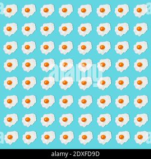 Pattern of fried eggs against blue background Stock Photo
