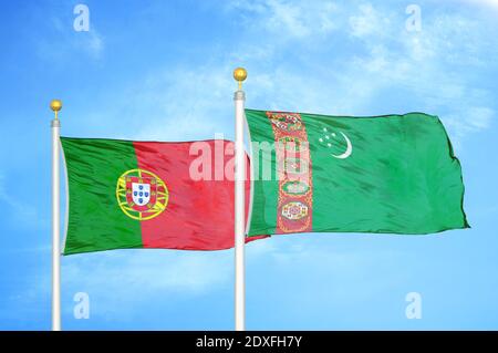 Portugal and Turkmenistan two flags on flagpoles and blue sky Stock Photo