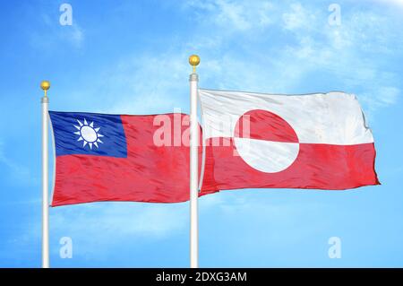 Taiwan and Greenland two flags on flagpoles and blue sky
