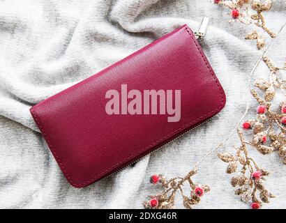 Red  leather wallet on grey knitted background Stock Photo