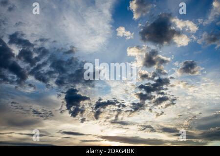 A Cumulus sunset clouds with sun setting down Stock Photo