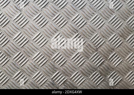 A Industrial metal checker plate. Metal checker plate texture background. Metal checkerplate for anti skid. Embossed metal sheet. Stock Photo
