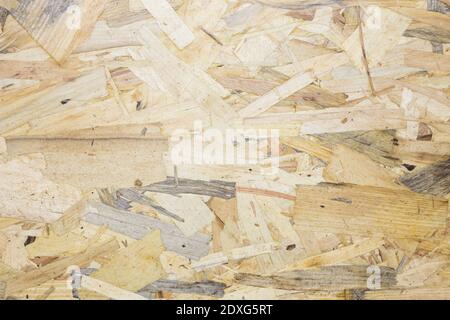 A close up pressed wooden panel background, seamless texture of oriented strand board - OSB wood Stock Photo