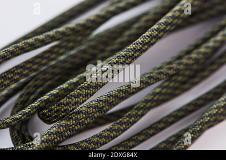 Close-up on black and green paracord on white background Stock Photo
