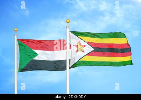 Sudan and Zimbabwe two flags on flagpoles and blue sky Stock Photo