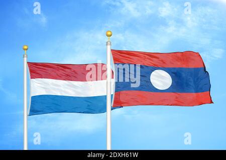Netherlands and Laos two flags on flagpoles and blue sky Stock Photo