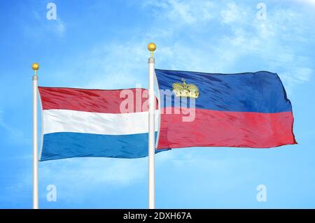 Netherlands and Liechtenstein two flags on flagpoles and blue sky Stock Photo