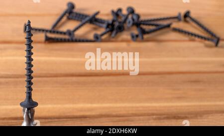 A screwdriver and self-cutters on a brown wooden background. Building tools to repair the house Stock Photo