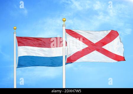 Netherlands and Northern Ireland two flags on flagpoles and blue sky Stock Photo