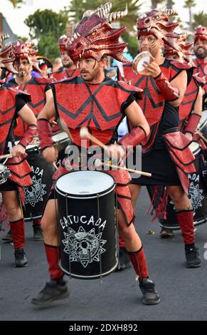 Male carnival drummer in red costume marching and playing. Stock Photo