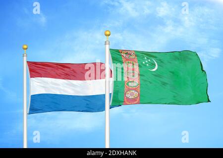 Netherlands and Turkmenistan two flags on flagpoles and blue sky Stock Photo