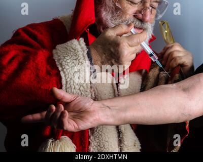 Santa Claus is ready to deliver vaccination to humanity Stock Photo