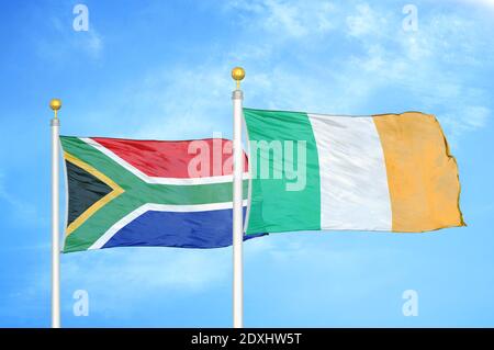 South Africa and Ireland two flags on flagpoles and blue sky Stock Photo