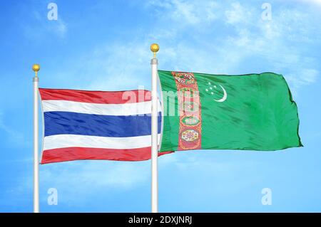 Thailand and Turkmenistan two flags on flagpoles and blue sky Stock Photo