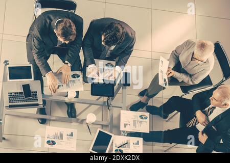 top view. working group discusses financial indicators. Stock Photo