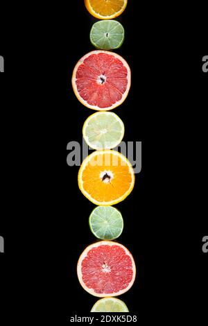 citrus slices, ,orange, lemon, lime, and grapefruit black background. Top view Stock Photo