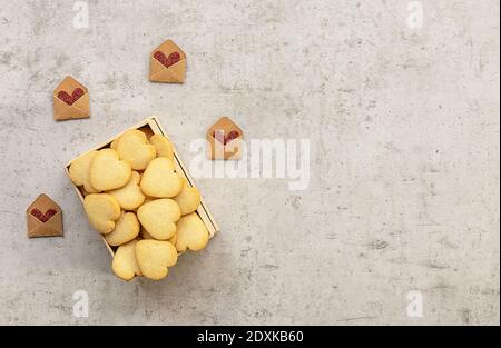 Homemade heart shaped cookies in a box. Valentines Day greeting card with holiday decorations. Flat lay, copy space Stock Photo