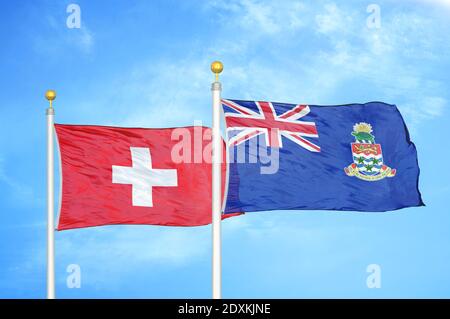 Switzerland and Cayman Islands two flags on flagpoles and blue sky Stock Photo