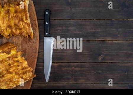 Knife and pastry on wooden table Stock Photo