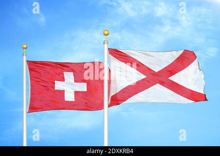 Switzerland and Northern Ireland two flags on flagpoles and blue sky Stock Photo