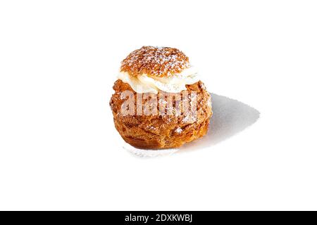 Rum baba with butter cream on a light background. Home delivery. Festive concept. Quarantine. Copy space. Stock Photo