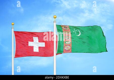 Switzerland and Turkmenistan two flags on flagpoles and blue sky Stock Photo