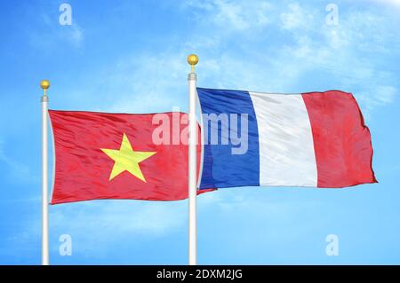 Vietnam and France two flags on flagpoles and blue sky Stock Photo