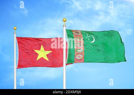 Vietnam and Turkmenistan two flags on flagpoles and blue sky Stock Photo