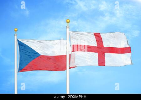 Czech and England two flags on flagpoles and blue cloudy sky Stock Photo