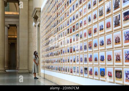 London, UK, 24th July 2020. An assistant looks at images from the Steve McQueen exhibition 'Year 3, A Portrait of London'. Stock Photo