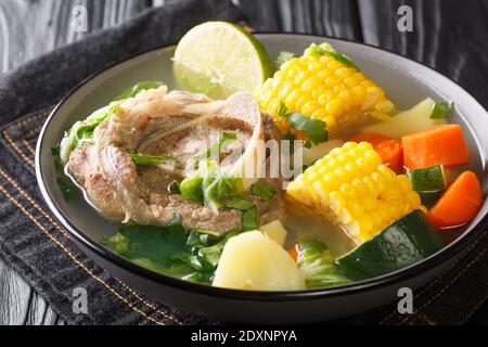 Delicious Caldo de res Mexican beef shank soup with vegetables close-up in a bowl on the table. horizontal Stock Photo