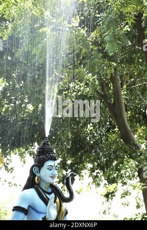 Statue of lord Shiva and Background raining Stock Photo