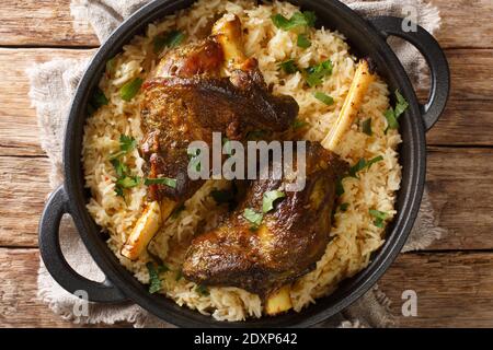 Haneeth is a slow roasted lamb dish from Yemen served on a plate of rice closeup on the table. horizontal top view from above Stock Photo