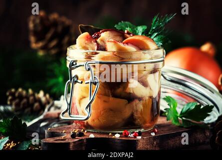 Salted or marinated forest white mushrooms  boletus in jar with spices and herbs, cooking food or canning concept, wooden kitchen table, copy space, r Stock Photo