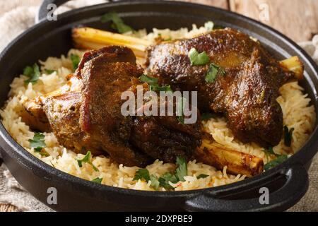 Haneeth is a slow roasted lamb dish from Yemen served on a plate of rice closeup on the table. horizontal Stock Photo