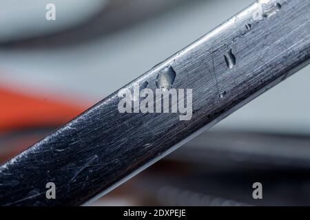 Macro of a piece of steel with water drops. Stock Photo