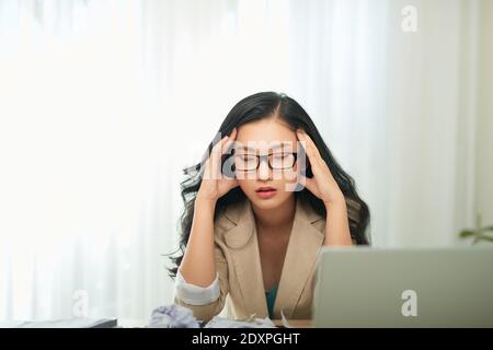 Young and beautiful businesswoman tired from work in the office Stock Photo